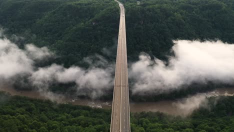 New-River-Gorge-Bridge,-Aerial-View-of-Interstate-Route-and-Clouds-Under-Arch
