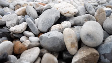 Round-pebble-beach-grey-texture-stones-closeup-shallow-focus-dolly-right