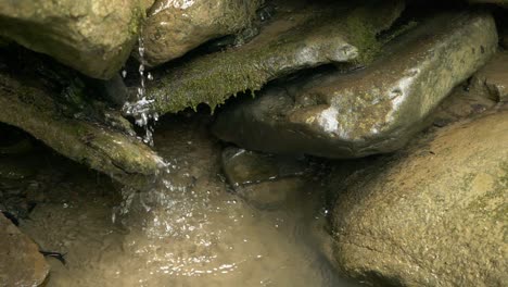 Slow-Motion-of-Water-Gently-Dropping-Over-Mossy-and-Smooth-Stones,-Full-HD