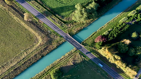 wide-drone-shot-of-van-over-bridge-in-country