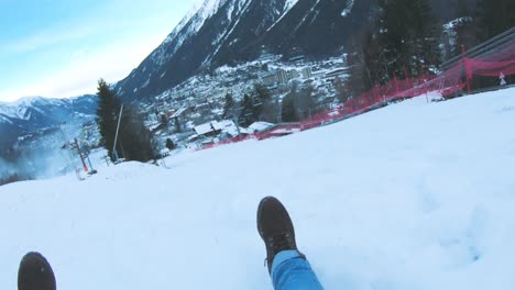 Snow-sledding-fun-down-the-slope-in-Chamonix,-France---wide