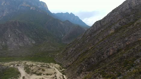 Beautiful-valley-of-La-Huasteca-park-in-Mexico-with-riverbed-under-high-rocky-mountains