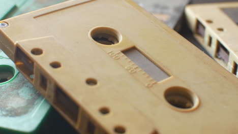 Audio-cassettes-on-a-table-dolly-in-extreme-close-up-shot