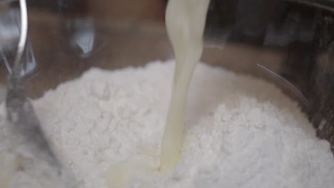 Mixing-buttermilk-into-flour-to-make-delicious-homemade-dough---slow-motion