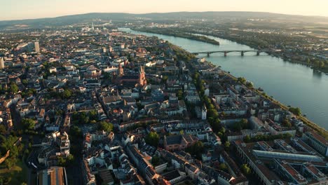 Flying-into-a-sunny-summer-Morning-in-Mainz-with-a-drone-and-the-Rhine-river-with-its-old-bridge-in-the-background