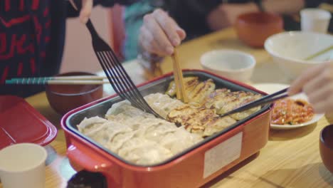 Turning-A-Tasty-Gyoza-Dumplings-And-Cooked-With-A-Bruno-In-A-Sharehouse-In-Kyoto,-Japan