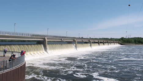 People-fishing-in-front-of-a-hydroelectric-dam