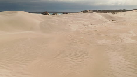 Aerial-over-a-safari-jeep-vehicle-driving-across-the-sand-dunes-near-Port-Lincoln-in-South-Australia
