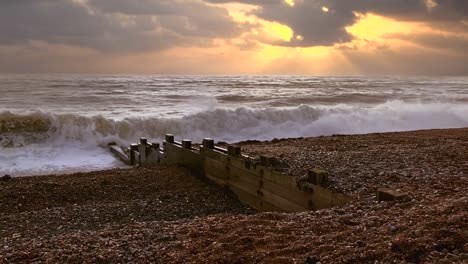 Rough-waves-rolling-and-crashing-up-a-shingle-beach-at-sunrise-on-the-English-South-Coast-in-super-slow-motion