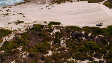 Aerial-shot,-Jeep-safari-between-sand-dunes-and-the-ocean