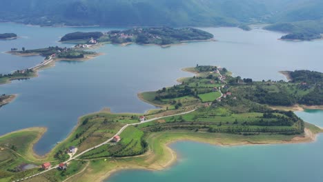 Rama-Lake-in-Bosnia-and-Herzegovina-with-peninsula-islands-below,-Aerial-pedestal-lift-shot-wide-view