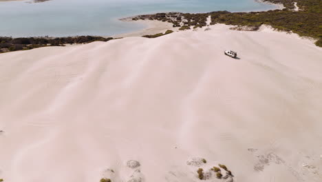 Aerial-over-a-4WD-safari-jeep-vehicle-driving-across-the-sand-dunes-of-South-Australia