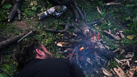Man-Blowing-Harder-On-A-Campfire-During-Daytime-In-Manali,-Himachal-Pradesh-India