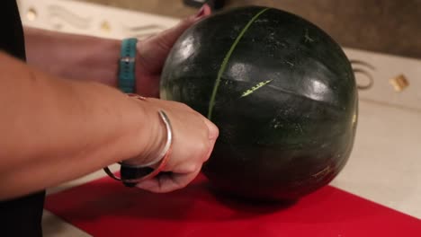 Woman-cutting-up-black-diamond-seedless-watermelon