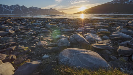Peaceful-midnight-sun-time-lapse-view-from-shore-of-Lyngen-fjord,-Norway