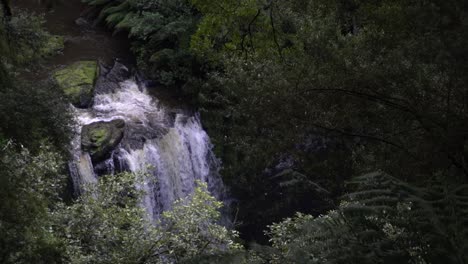 View-of-large-waterfall-stream-from-above-amongst-rainforest