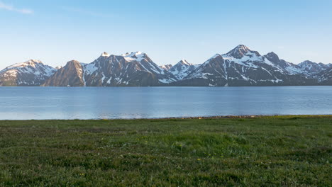 Majestic-Lyngen-Alps-mountains-across-water-of-fjord,-Norway-time-lapse