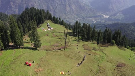 Hikers-Trekking-In-Sar-Pass-Trek-In-A-Sunny-Afternoon---aerial-shot