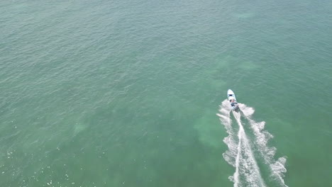 Aerial-Drone-Footage-of-Panga-Speedboat-charging-across-ocean-in-Ascension-Bay,-Punta-Allen,-Mexico