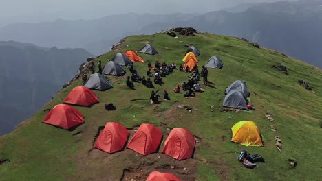 Fly-Over-Camping-Site-Of-Hikers-In-Sar-Pass,-India---aerial-shot