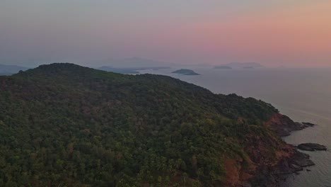 Aerial-View-Of-Tropical-Mountain-With-Rainforest-On-The-Rocky-Shore-Of-Goa-Beach-In-India