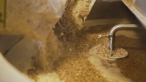 Pouring-Bags-Of-Malt-Into-The-Miller-Tank---Beer-Making-In-The-Brewery---close-up-slowmo