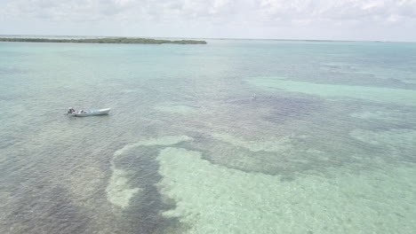 Aerial-Drone-Footage-of-panga-boat-fly-fishing-at-Ascension-Bay,-Punta-Allen,-Mexico