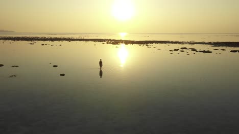 lone-male-enjoying-sunrise-in-an-island