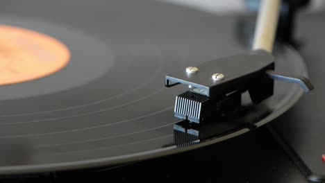 Vinyl-record-player-spinning-on-vintage-vinyl-turntable-player-and-vinyl-record-with-dropping-stylus-needle