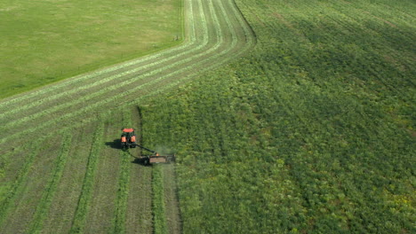Making-Hay-With-A-Tractor-At-Daytime-In-Saskatchewan,-Canada---Aerial-Shot