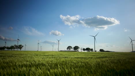 Panoramic-shot-of-a-windmill-farm,-in-a-country-field,-on-a-sunny-and-windy-day