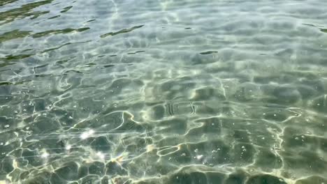 Fluorescent-twinkling-light-in-crystal-clear-water-in-slow-motion