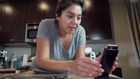 Woman-at-home-video-calling-friends-and-family-on-mobile-phone,-no-makeup