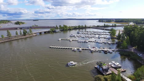 Boats-docked-at-harbor,-Coast-town-of-Vaasa,-Finland,-Drone-shot
