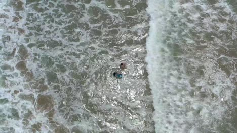 Kids-body-surfing-at-Ventura,-California-beach