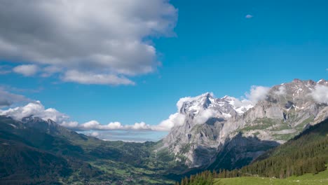 Breathtaking-view-of-Grindelwald-in-Switzerland,-clouds-rolling-over-Wetterhorn,-time-lapse