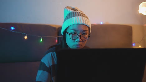 Slow-motion-stock-video-of-a-female-professional-gamer-playing-online-video-games-on-a-laptop-from-home
