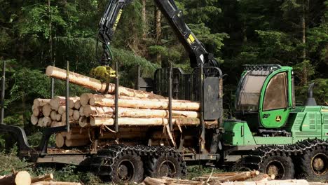 Forestry-harvester-loading-timber-mid-shot,-Highlands,-Scotland