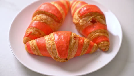 fresh-croissant-with-strawberry-jam-sauce-on-plate