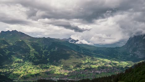 Rain-clouds-pass-over-Grindelwald-valley-casting-shadows,-sunlight-peeks-through,-time-lapse