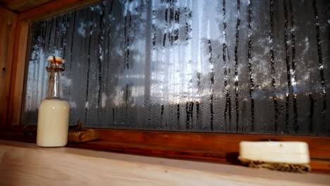 interior-of-Finnish-sauna,-window-view-of-a-summer-night-in-Finland