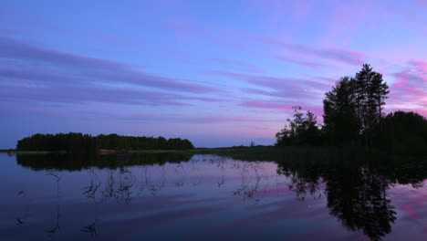 Time-lapse-of-beautiful-colorful-clouds-moving-above-a-lake-by-golden-hour