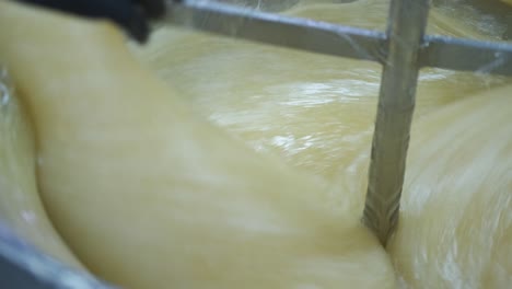 Close-up-of-a-vat-of-Turkish-delight-at-the-factory-as-a-worker-adds-the-flavoring
