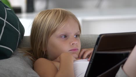Slow-motion-of-young-girl-looking-at-tablet-screen