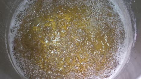 Close-up-of-a-pot-of-boiled-honey-at-the-factory-as-they-prepare-to-sugar-the-almonds-to-make-Turkish-Delight