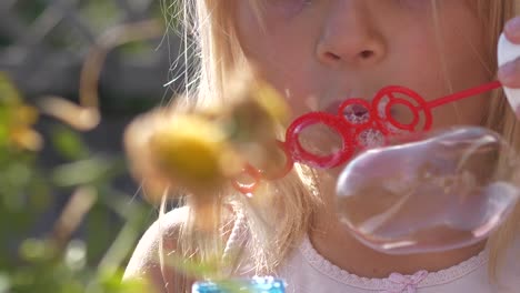 Blonde-summer-girl-blows-bubbles-with-wand