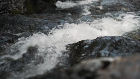Close-up-of-small,-fast-river-flowing