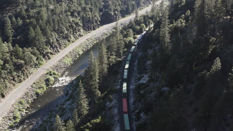 Plumas-National-Forest-with-a-long-cargo-train-traveling-through-valley-below