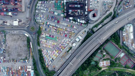 Hong-Kong-commercial-port-dock-and-holding-platform-with-thous-of-Shipping-Containers,-Aerial-view