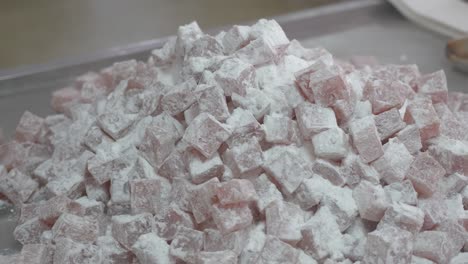 Close-up-as-a-large-batch-of-finished-Turkish-delight-is-emptied-onto-a-table-for-packaging
